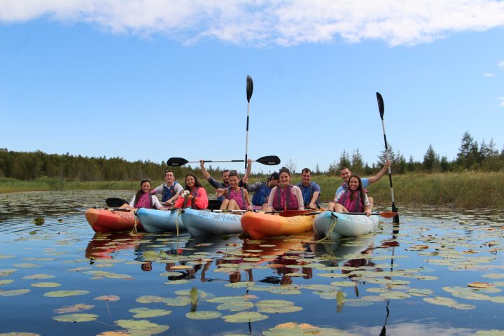 a group of people in a small boat in a body of water