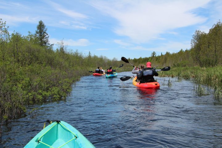 three kayakers at cave point county park