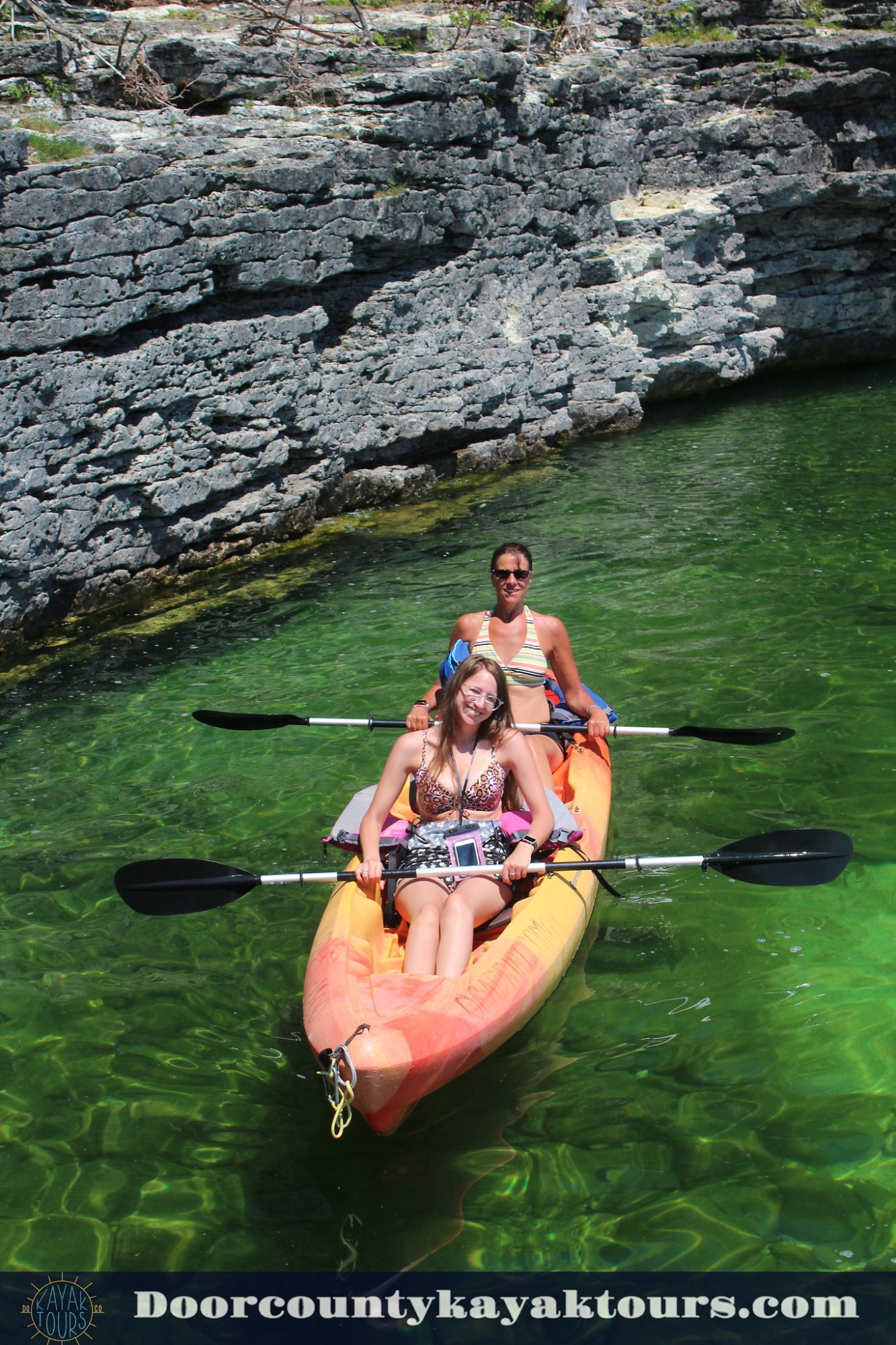 cave point county park kayak tours a man rowing a boat in the water