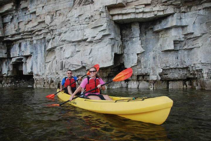 a person riding on the back of a boat in the water