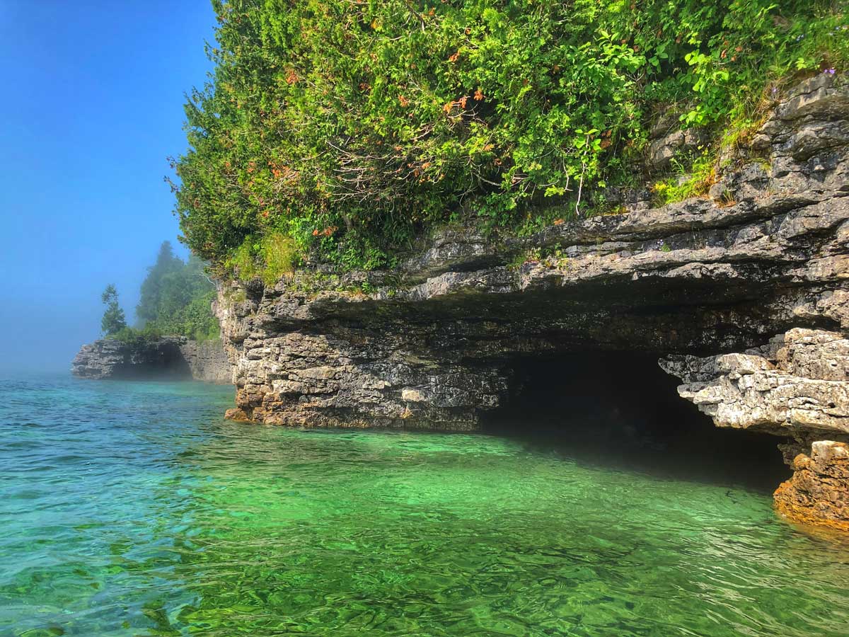 The view of the cave point cove at cave point county park from the view of a kayak