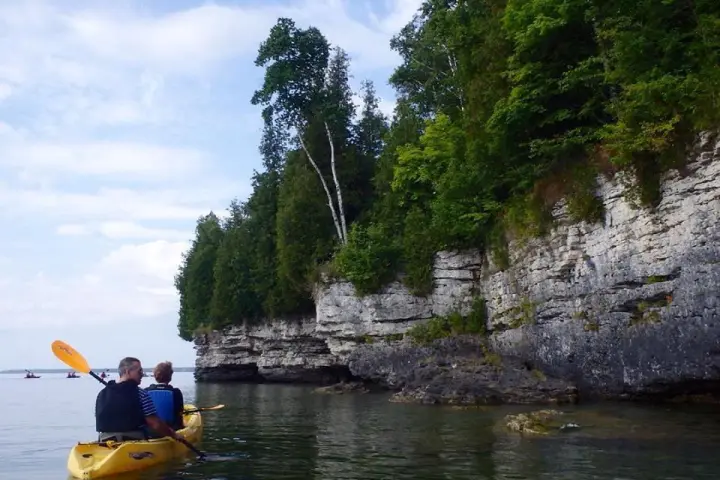 a man in a yellow boat in the water