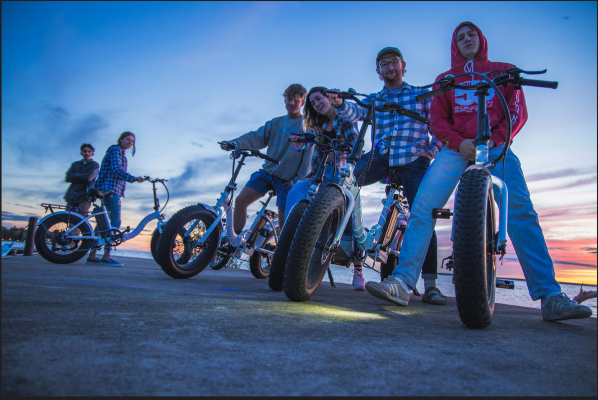 header-image-sunset-glow-roll-fish-creek-peninsula-state-park a group of people riding on the back of a motorcycle